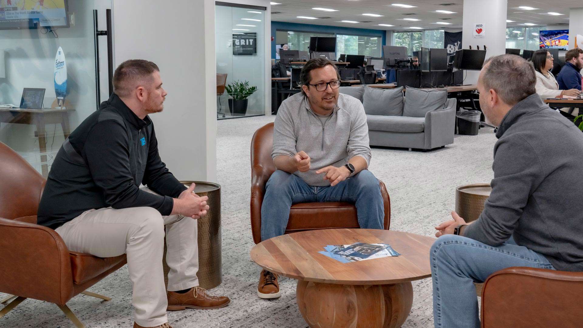 Trailer Bridge CEO, Mitch Luciano, sitting and talking to employees