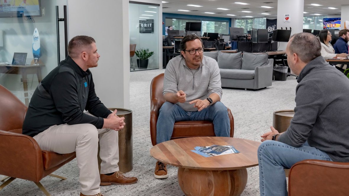 Trailer Bridge CEO, Mitch Luciano, sitting and talking to employees