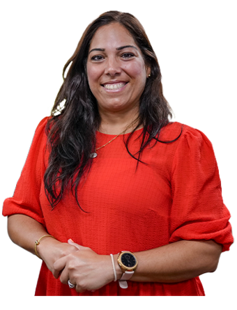 A Trailer Bridge employee smiles at the camera while standing.