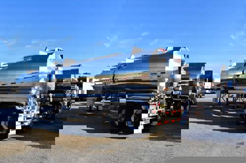 A line of tanker trailers in a lot.