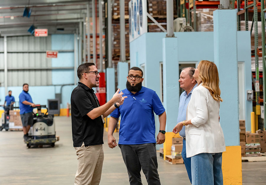 Employees meeting with warehouse workers in Puerto Rico.