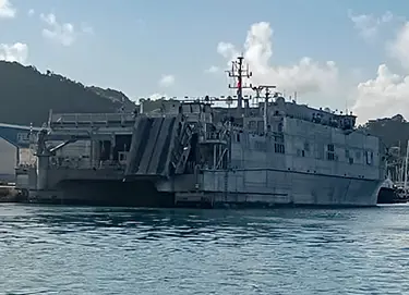 A military transport ship at port.