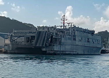 A military transport ship at port.