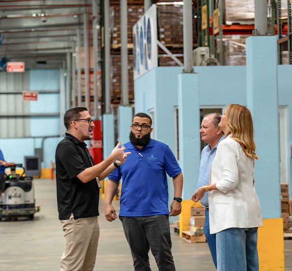 Employees meeting with warehouse workers in Puerto Rico.