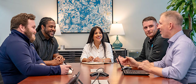 Group of Trailer Bridge employees meeting in a conference room.