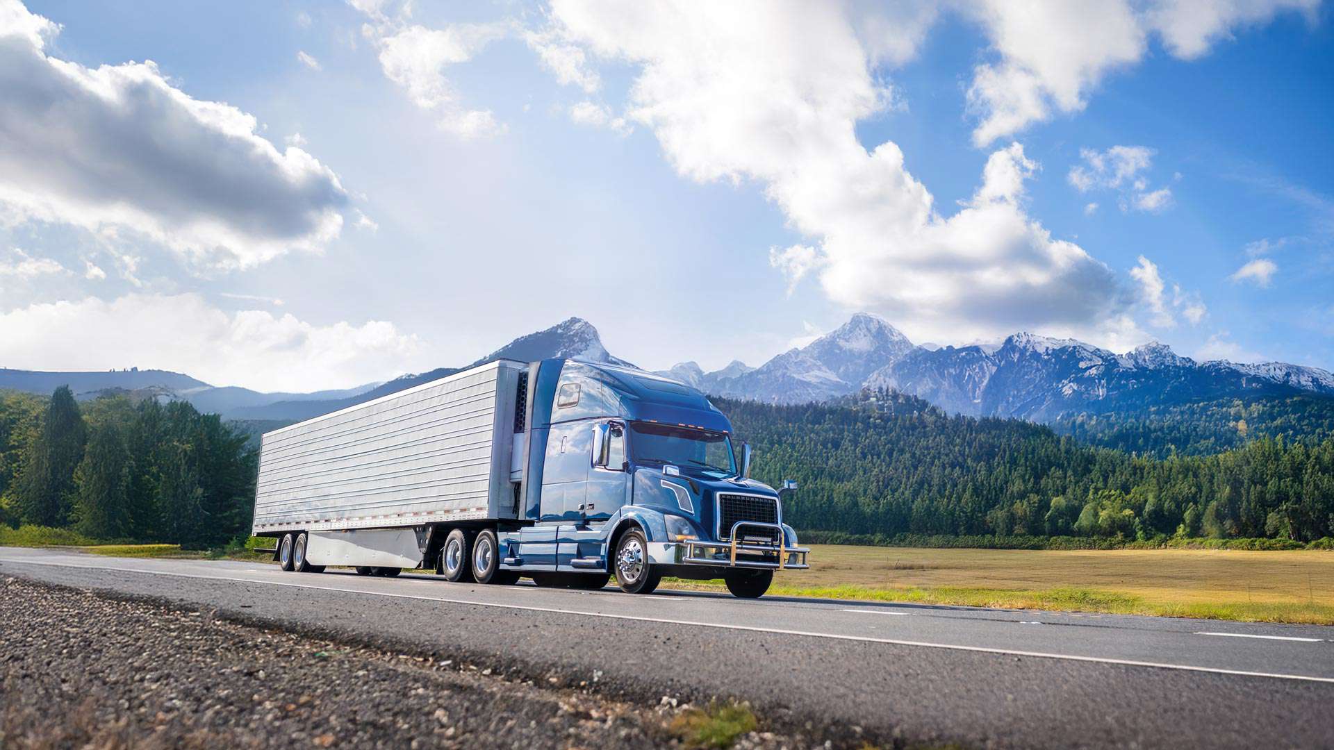 Truck With Reefer Driving Down Road 1