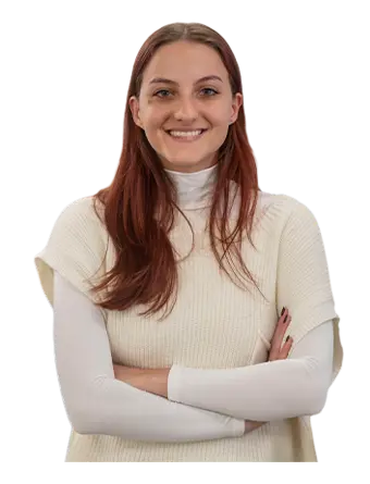 A Trailer Bridge employee smiles at the camera while standing.