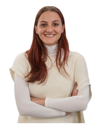 A Trailer Bridge employee smiles at the camera while standing.