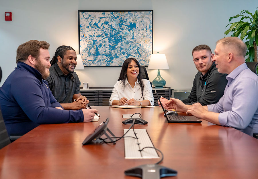 Group of Trailer Bridge employees meeting in a conference room.