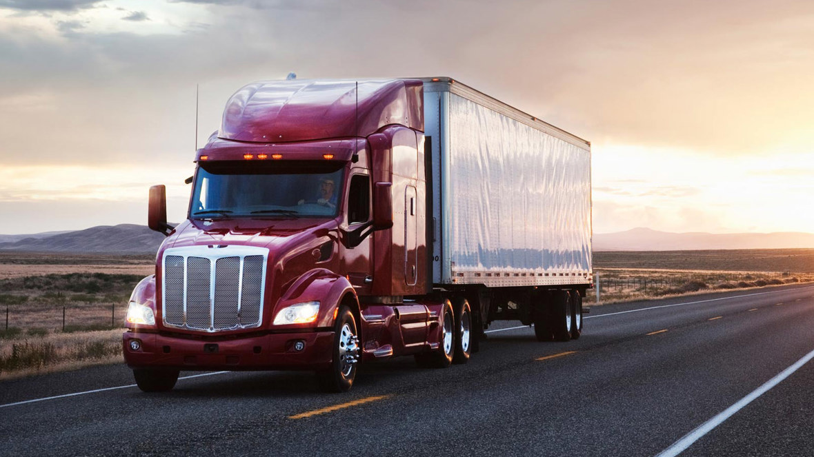 A truck drives down a quiet road.