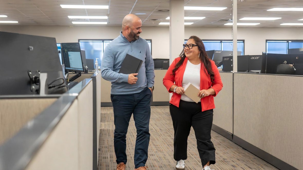 Two Trailer Bridge employees walking and talking.