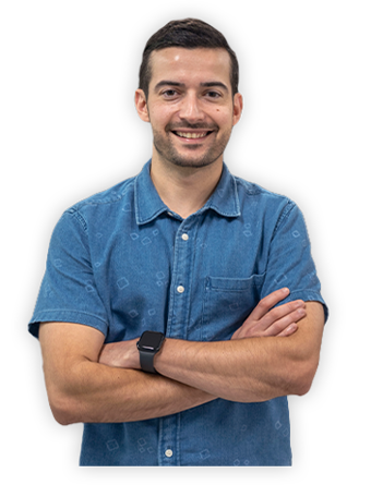 A Trailer Bridge employee smiles at the camera with arms crossed.
