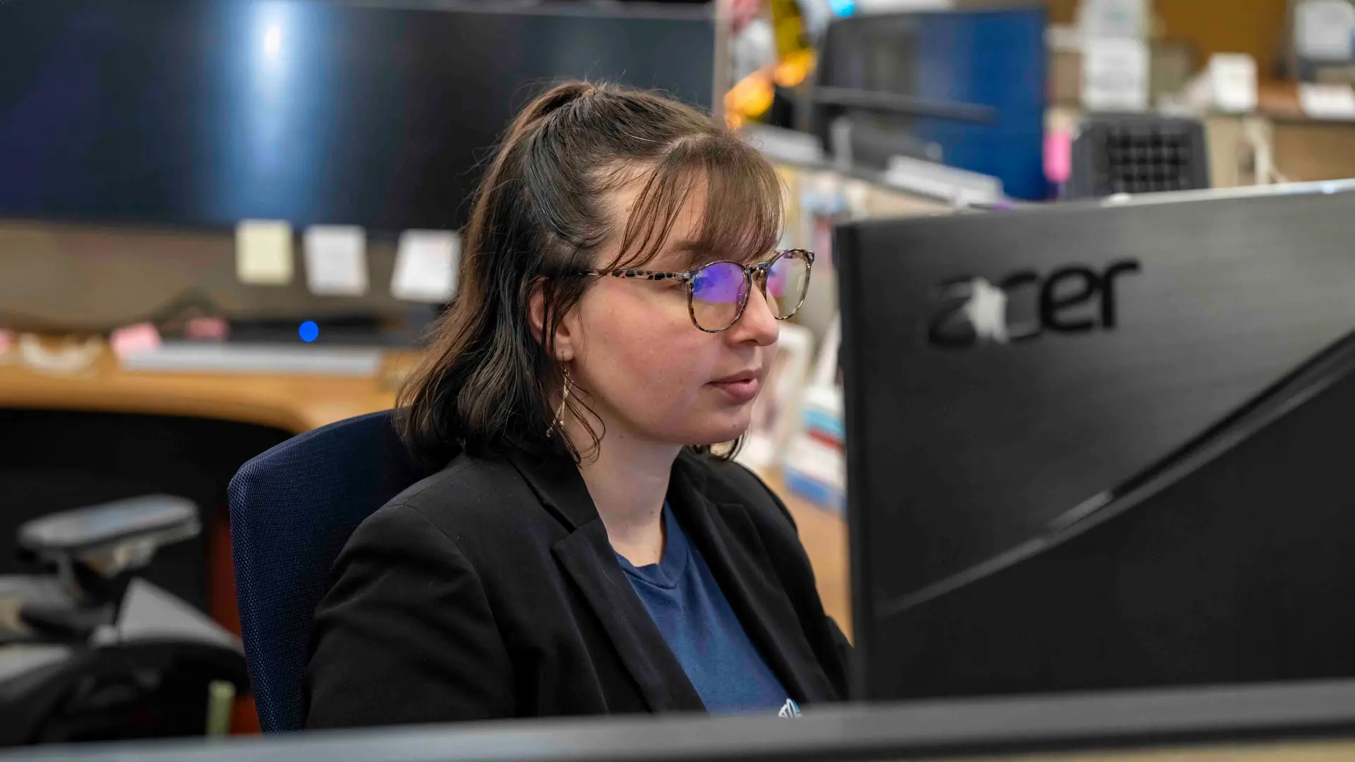 A Trailer Bridge employee works at their desk