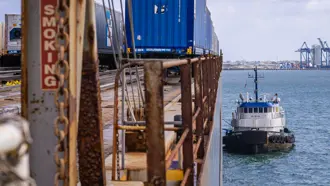 Tug boat pulled up next to a Trailer Bridge RORO barge. 