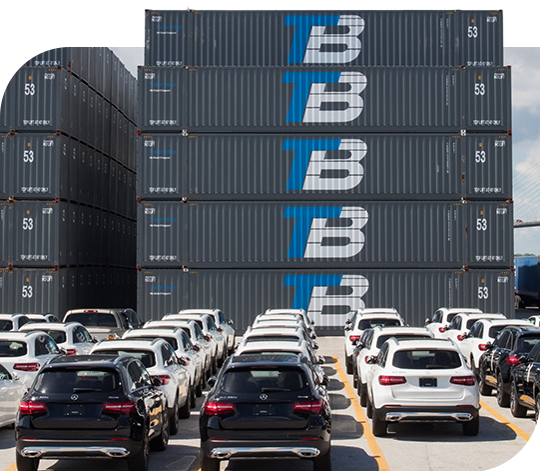 In the background are stacks of Trailer Bridge containers, while lines of cars are parked in the foreground.