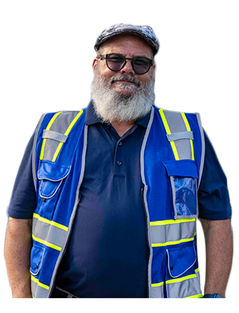 A Trailer Bridge employee wearing a high-visibility jacket smiled at the camera.