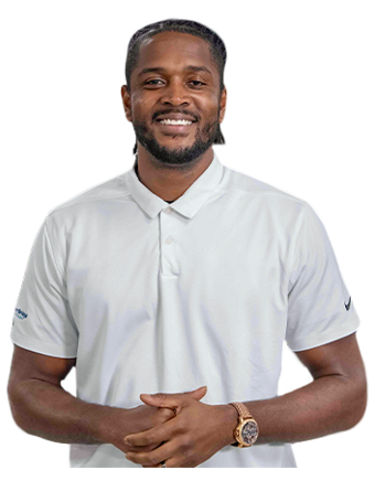 A smiling Trailer Bridge employee stands casually while looking at the camera.