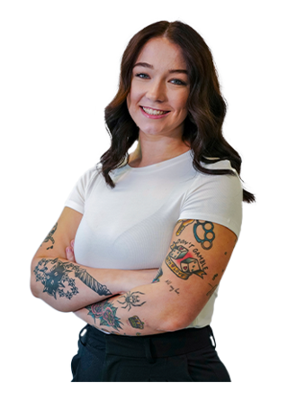 Arms crossed, a Trailer Bridge employee smiles at the camera.