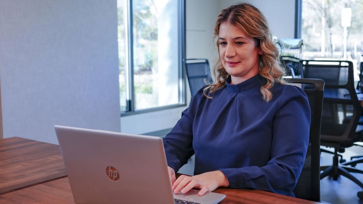 A person works on a laptop.
