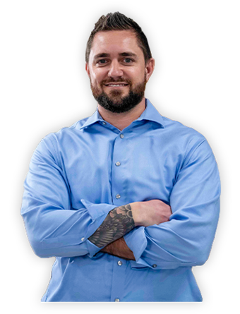 A smiling Trailer Bridge employee stands with arms crossed.
