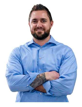 A smiling Trailer Bridge employee stands with arms crossed.