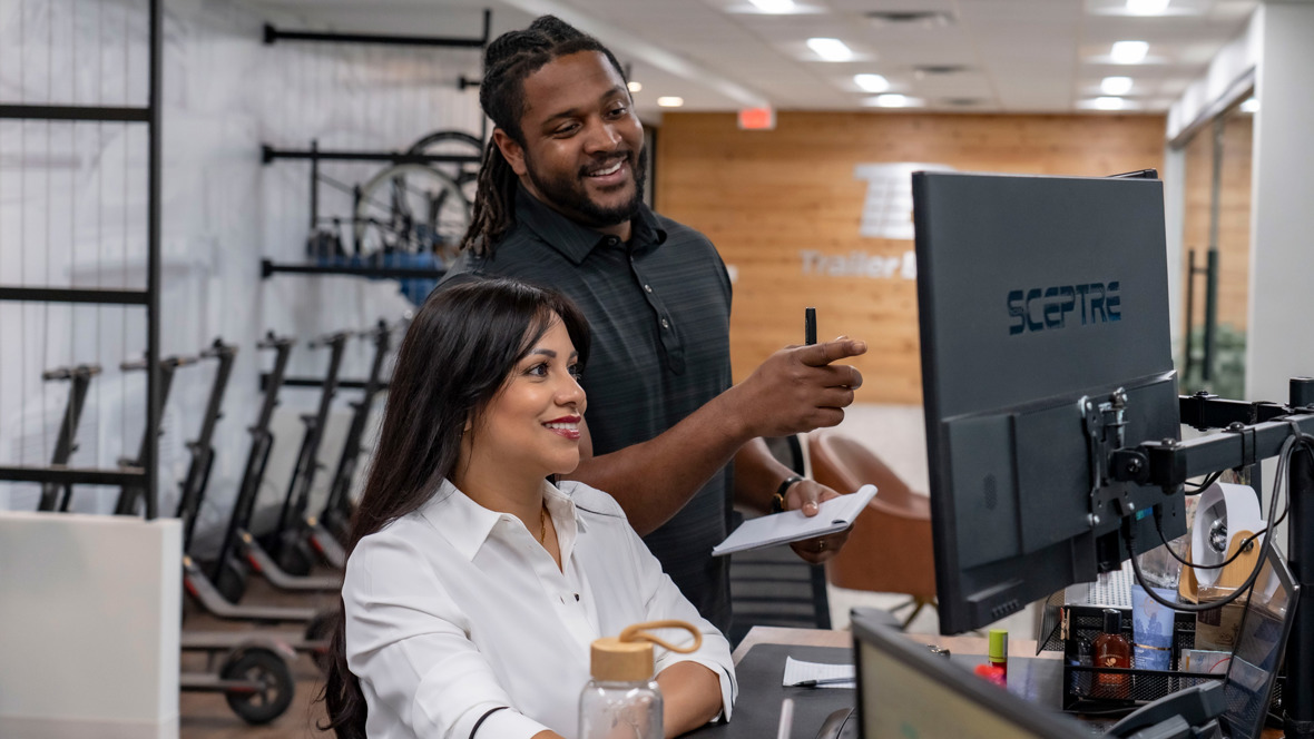 Trailer Bridge team mambers work together to book a international load
