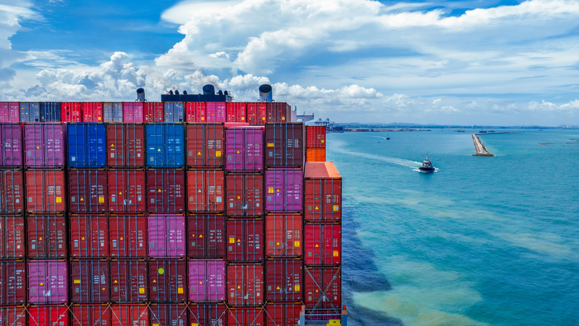 Containers stacked on a cargo ship leaving port