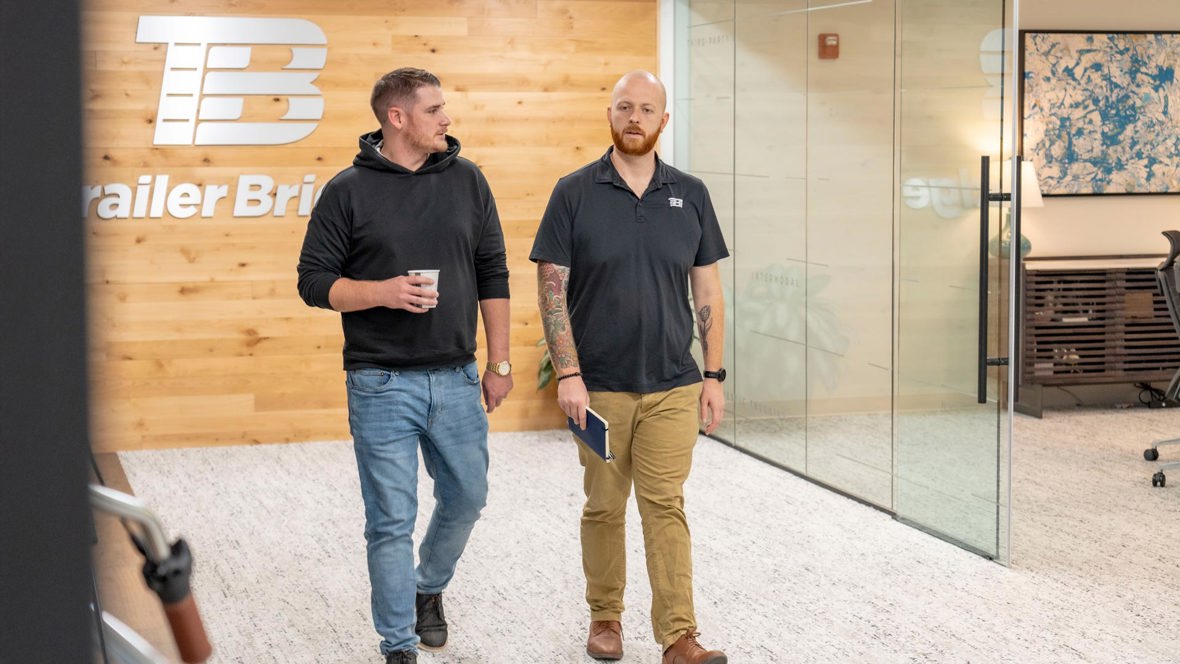 Two Trailer Bridge employees walk through the office.