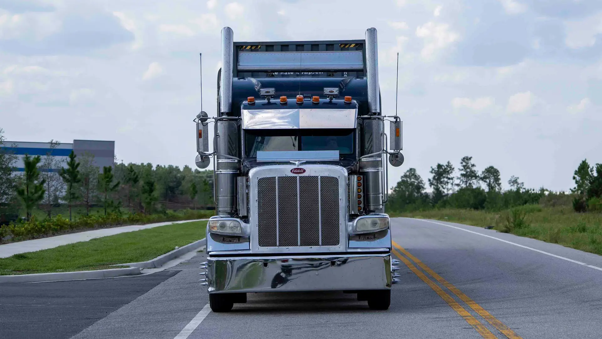 Front of a semi-truck on the road.