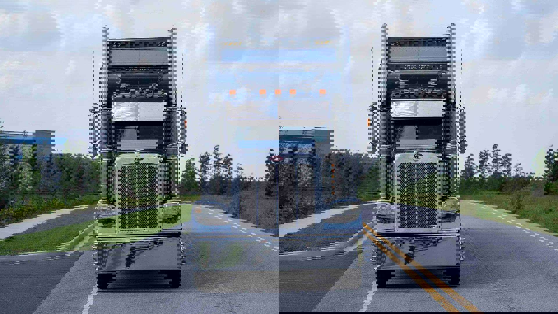 Front of a semi-truck on the road.