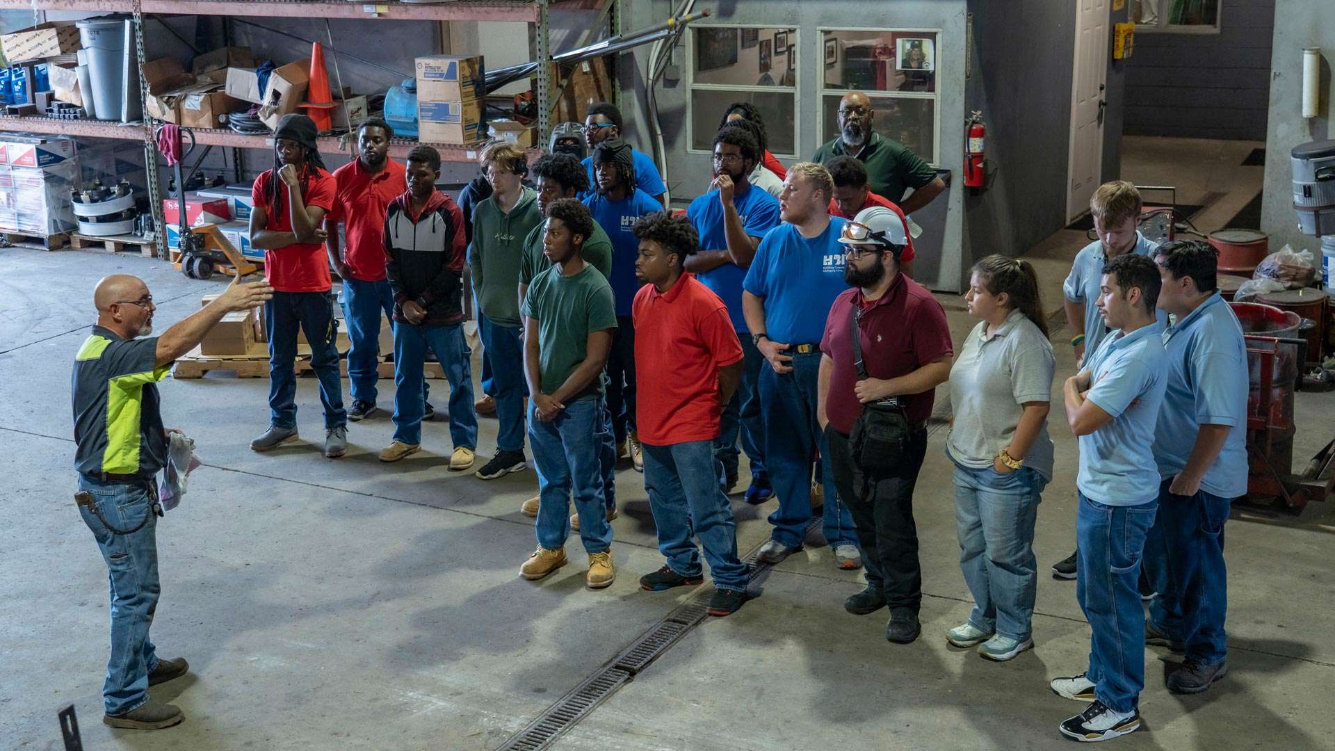Trailer Bridge maintenance worker speaking to a group from Job Corps.