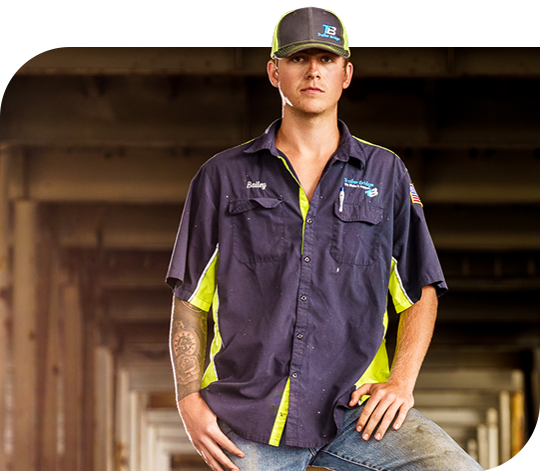 Employee in Trailer Bridge hat and shirt looks seriously at the camera.