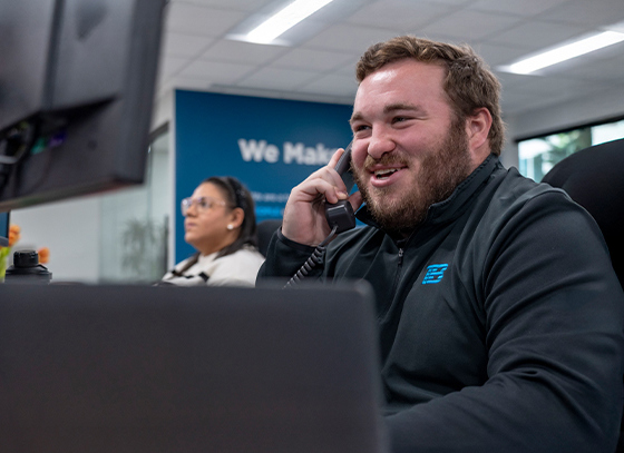 Image of a Trailer Bridge employee on the phone